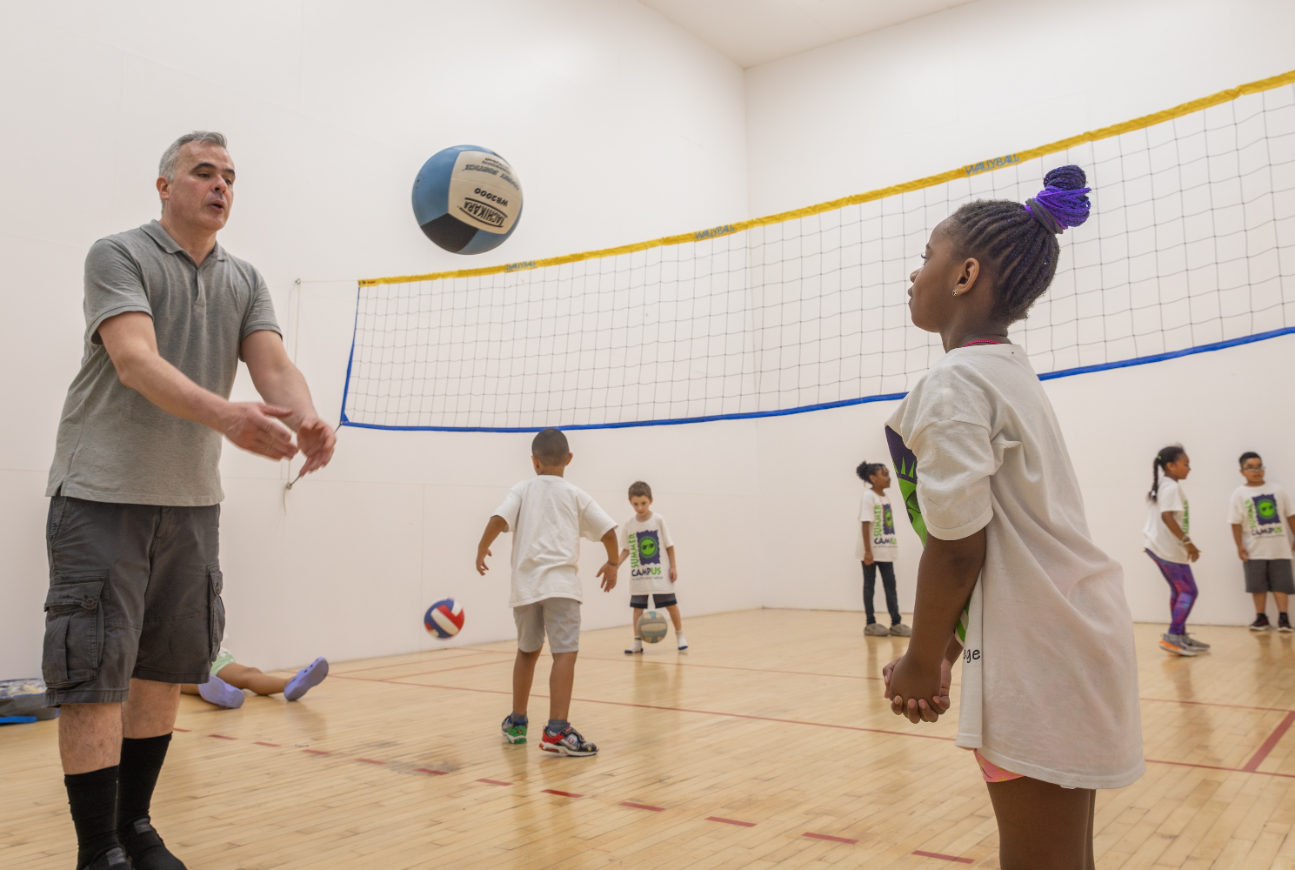 coach teaching students at summer camp